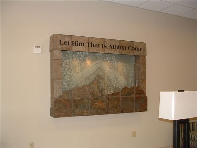 This project has been created for the seventh day Adventist church convention center located near Auburn WA. It is a 6' by 5' tall wall hanging piece that has a glass water surface showcasing a northwest mountain scene. There is lighting within the valance.