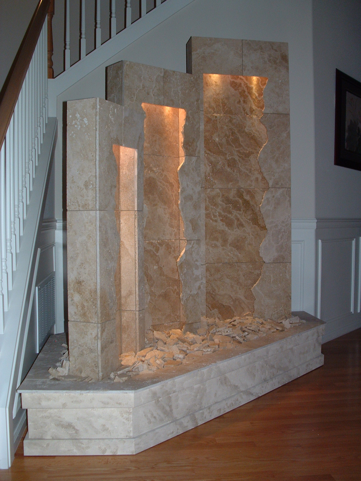 Redmond, WA. residence. Three-tower, fractured face (18 in x 50in- 20 in x 62in- 24 in x 72 in) each with valance lighting -a corner basin with custom stone like pint job and travertine basin cap, existing home.