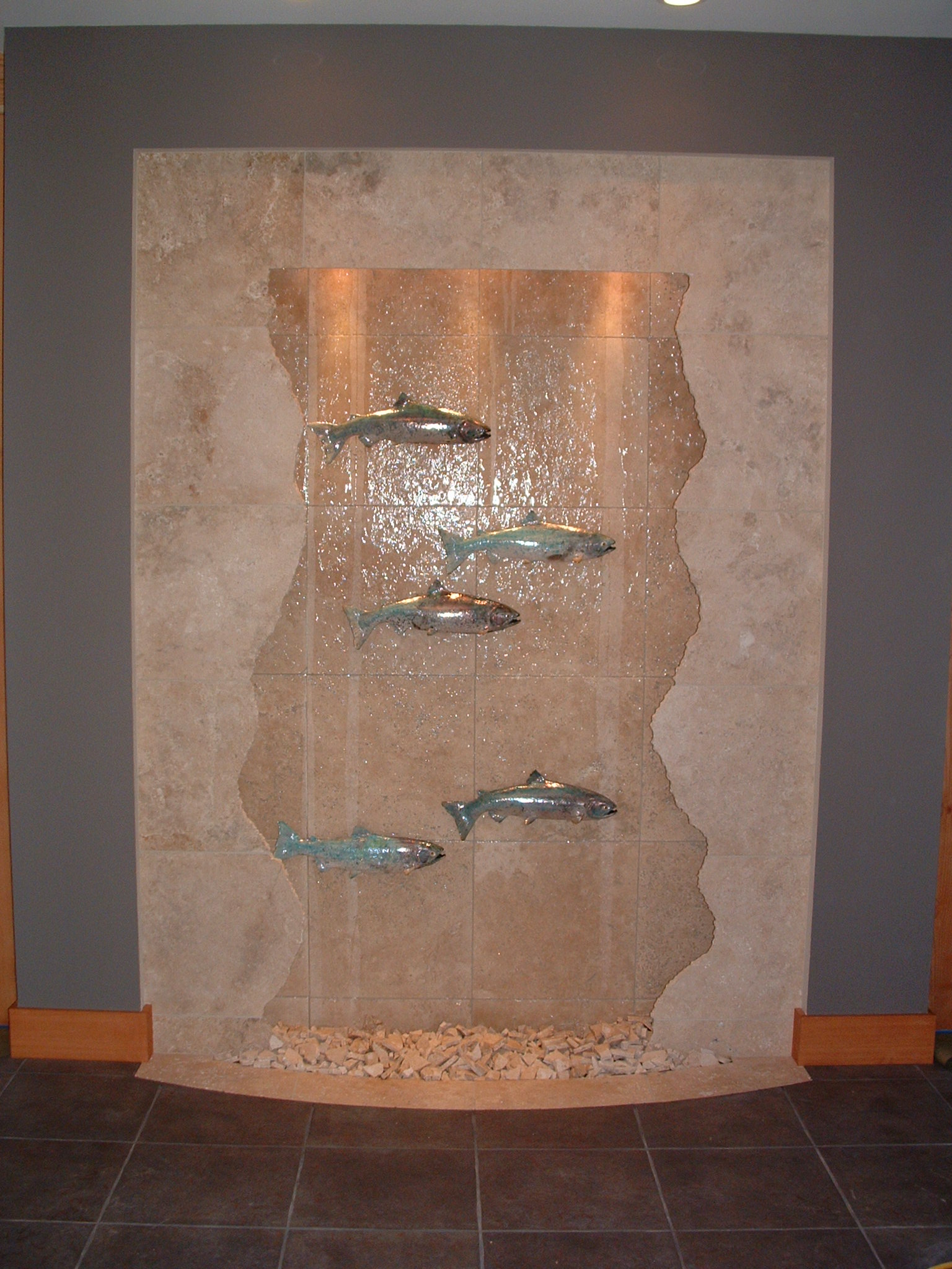 Gig Harbor, WA. residence, auto filled. 7 ft x 9ft tall fractured salmon wall, 5 racue glazed salmon lighting within valance hearth built into floor basin topped off with broken marble bits, new construction remote resicon location.