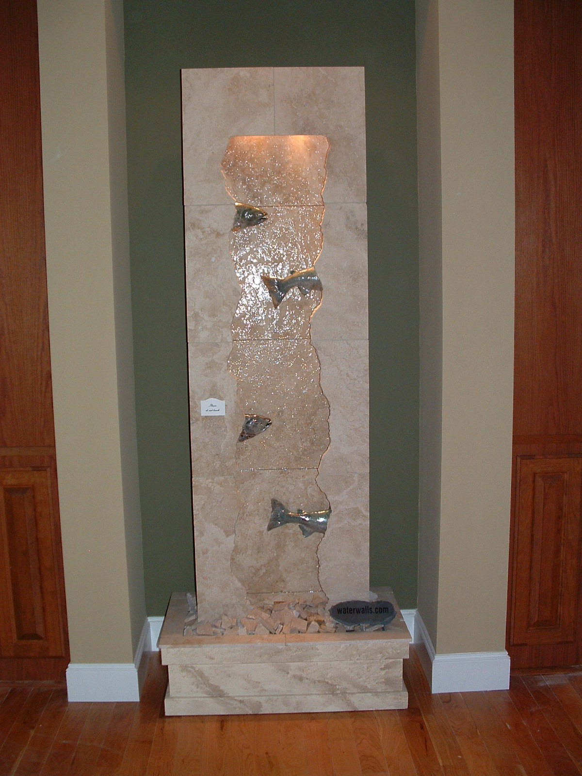 Kent, WA. Display for custom homebuilder, existing. 24 in. x 7 ft. tall, peek-a-boo salmon wall lighting in valance, basin topped out with travertine marble crumbles.