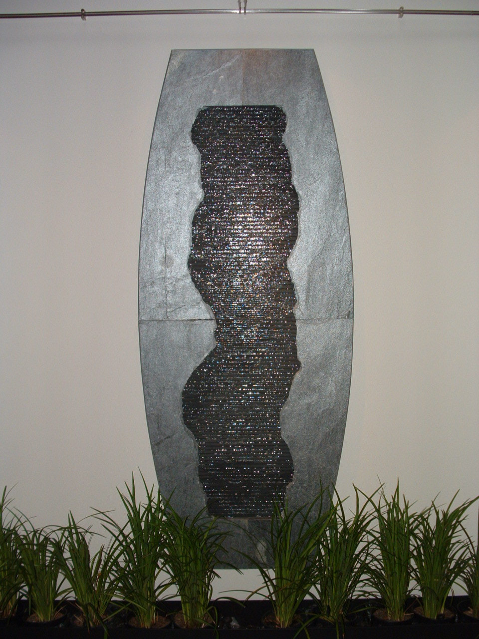Gig Harbor, WA. residence, existing home, wall hanging, Granite wave wall with slate slab foreground, 30 in x 7 ft. tall, remote basin, overhead lighting